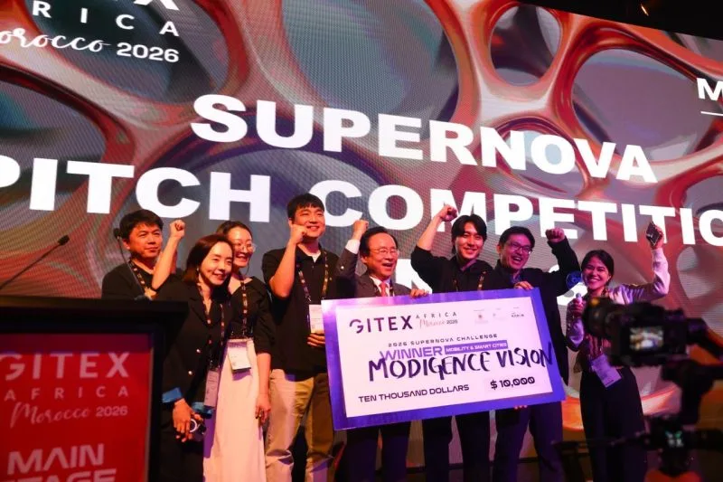The ModigenceVision team on the GITEX Africa main stage holding the Supernova Challenge winner’s check for the Mobility & Smart Cities category